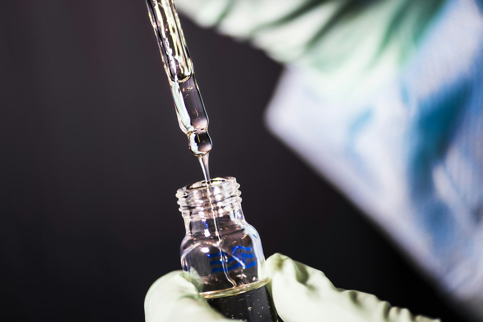 Pipette dispensing a laboratory sample into a vial